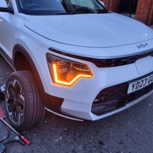 White car having tyre changed by mobile tyre fitting service